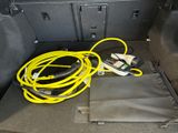 a yellow cable in the trunk of a car