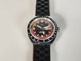 a watch that is sitting on a white surface