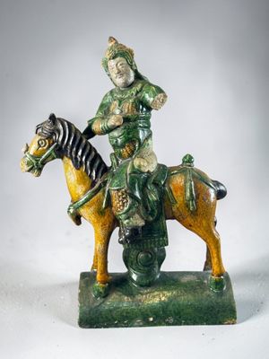figurine of a man riding a horse with a zebra on the back