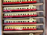 a wooden box with a bunch of toy trains in it