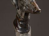 sculpture of a dog head on a plate on a marble surface