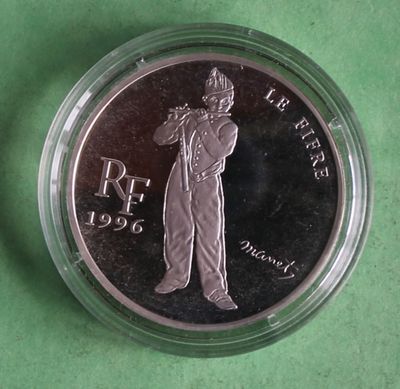a close up of a coin on a green surface