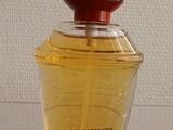 an image of a close up of a bottle of perfume on a table