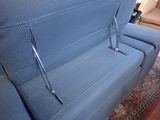 a blue couch that is sitting in a living room