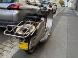 a scooter that is parked on the side of the street