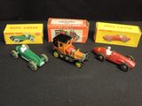several toy cars are lined up in a row on a black surface