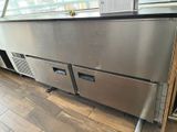 a stainless steel counter top with two drawers under it