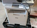 a printer that is sitting on a pallet in a warehouse