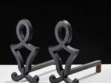 two metal sculptures that are sitting on a table