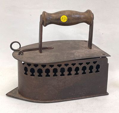 an old iron with a wooden handle on it