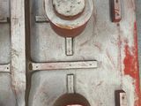 a close up of a piece of metal with pots and pans on it