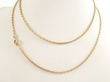 a close up of a mannequin wearing a gold chain necklace