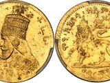 a close up of a gold coin with an image of a man on it