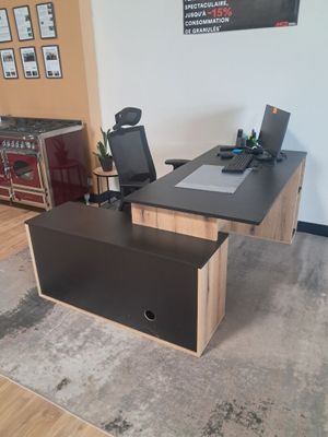a desk with a chair and a monitor on it