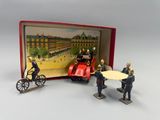 toy figurines of men in uniforms and a car in a box
