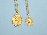 a pair of gold necklaces with a face of jesus on it