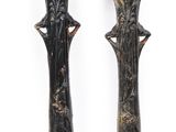 pair of black and gold candlesticks on a white background