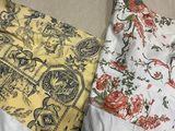 two pillows that are sitting on a bed together