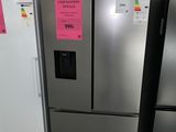 three refrigerators that are sitting side by side in a room