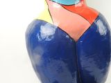 a colorful sculpture of a woman on a black base