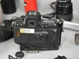 a black camera sitting on top of a table next to other cameras