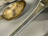 two spoons and a spoon rest on a table