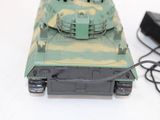 a toy tank that is sitting next to a mouse