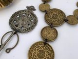 several pieces of jewelry are displayed on a white surface