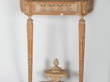 an old wooden table with a marble top and a vase on top of it