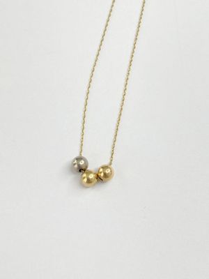 a gold and silver beaded necklace on a white background