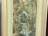 two framed paintings of a waterfall and a waterfall in a forest