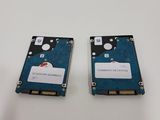 two hard drives are sitting side by side on a white surface