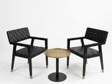 two chairs and a table in a white room with a white background