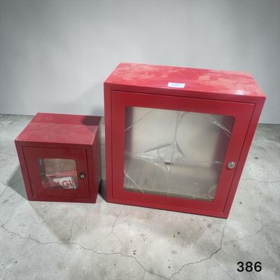 une petite vitrine rouge avec une porte vitrée, à côté d'une petite vitrine rouge avec une porte vitrée