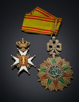 two medals and a ribbon on a black surface