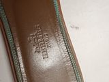 the bottom of a pair of brown and green shoes on a white surface