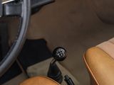 a steering wheel and dashboard of a car with tan leather seats