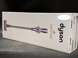 the box is open on a table with a cordless vacuum in it