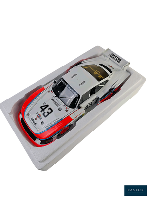 a model of a race car in a white box