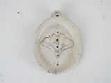 a white plate with a flower on it on a table