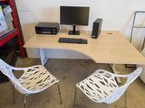 a desk with two chairs and a computer on it