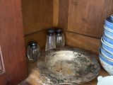 many plates and bowls on a shelf in a cabinet