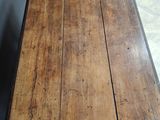an old table with a wooden top and a metal base