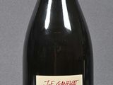 a bottle of wine sitting on a table with a label on it
