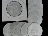 plusieurs pièces d'argent sur lesquelles figurent l'effigie d'un homme et d'une femme