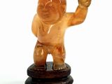 a small statue of a man on a wooden stand
