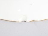a white plate with a hole in the middle of it