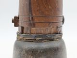a wooden object that is sitting on top of a metal container