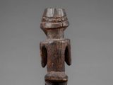 a wooden statue of a man with a hat on his head