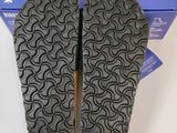 the soles of a pair of shoes are shown in front of a box